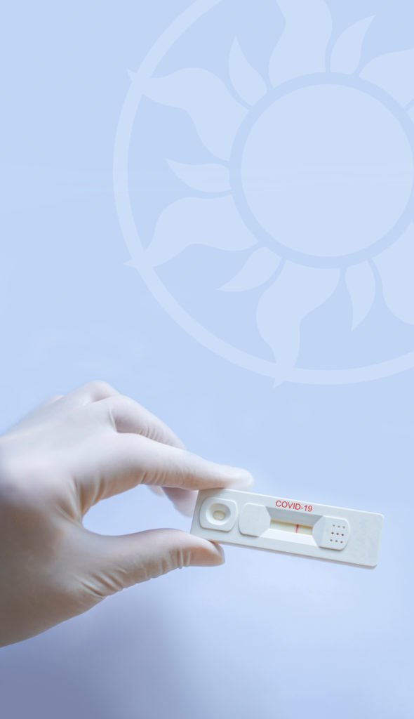 Doctor in a testing centre shows a rapid antigen test with a pos
