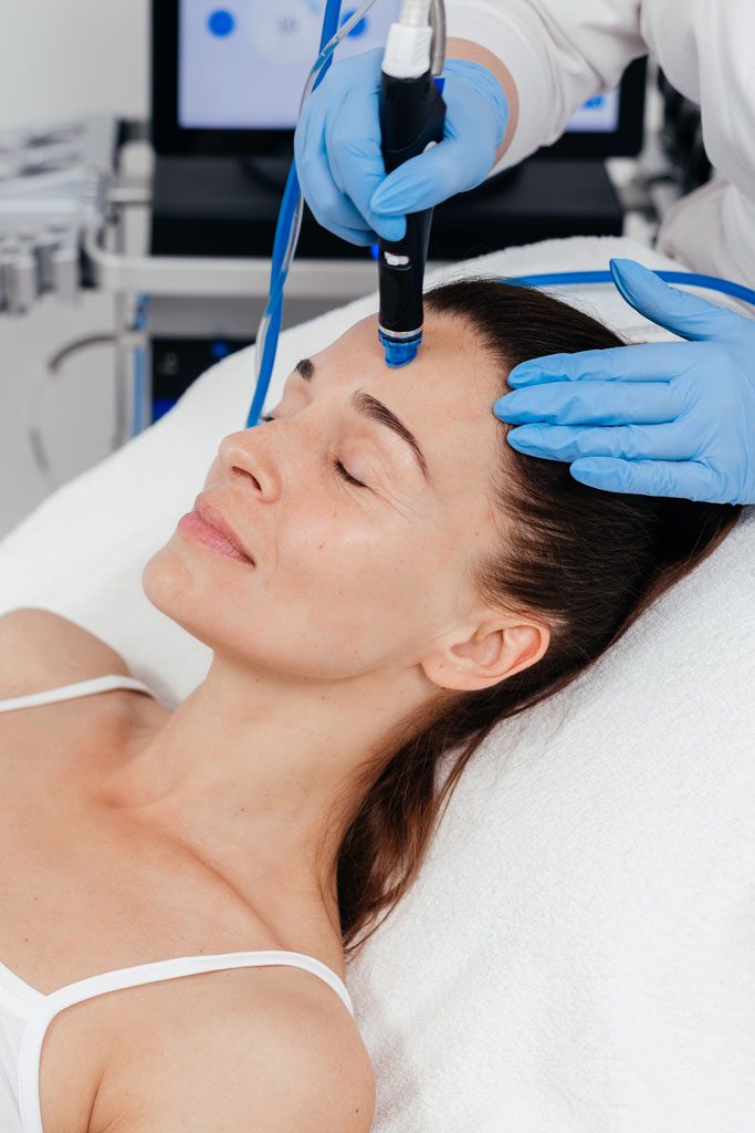 Middle aged woman receiving hydro facial lifting procedure. Natu